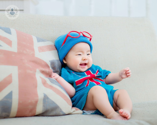 A picture of a baby laughing.