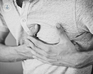 A man holding his chest in pain.