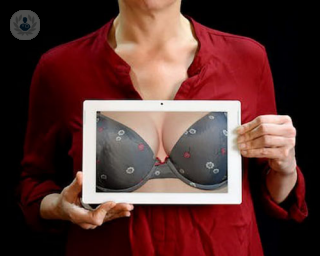 an image of a woman holding a picture of a bra