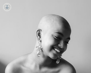 Black & white photo of a bald woman