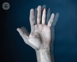 A person's hand out of focus, showing what diplopia looks like to people with this condition