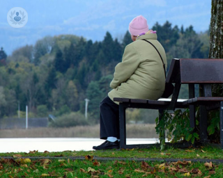 Lady with polymyalgia rheumatica (PMR) sat on a bench