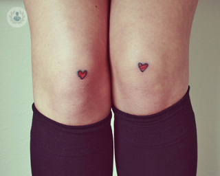 Knees with heart tattoos 