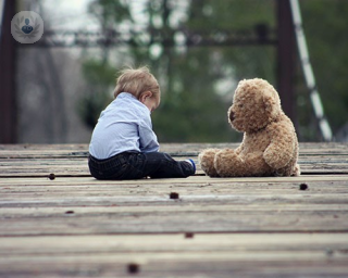 Child playing with teddy