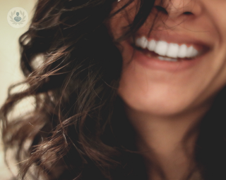 Woman smiling showing straight, white teeth