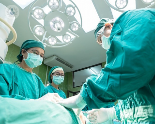 Surgeons performing surgery on a patient