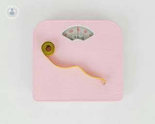 A pink weighing scales.