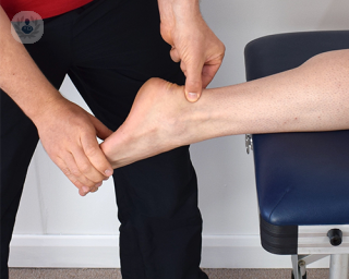 An ankle being examined by a specialist for ankle arthritis.