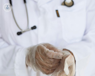 An image of a surgeon with surgical gloves on 