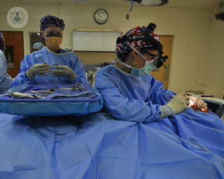 three surgeons preparing for a surgical procedure