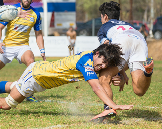 A rugby player tacking an opponent 