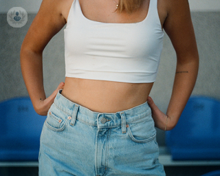 Young woman wearing jeans and a tank top