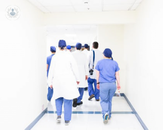 A group of surgeons and medical staff heading towards an operating theatre