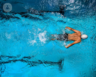 Athlete swimming in a pool wearing a swimming cap