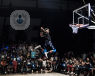Basketball player jumping to score a slam dunk