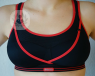 A woman who may have uneven breasts wearing a sports bra