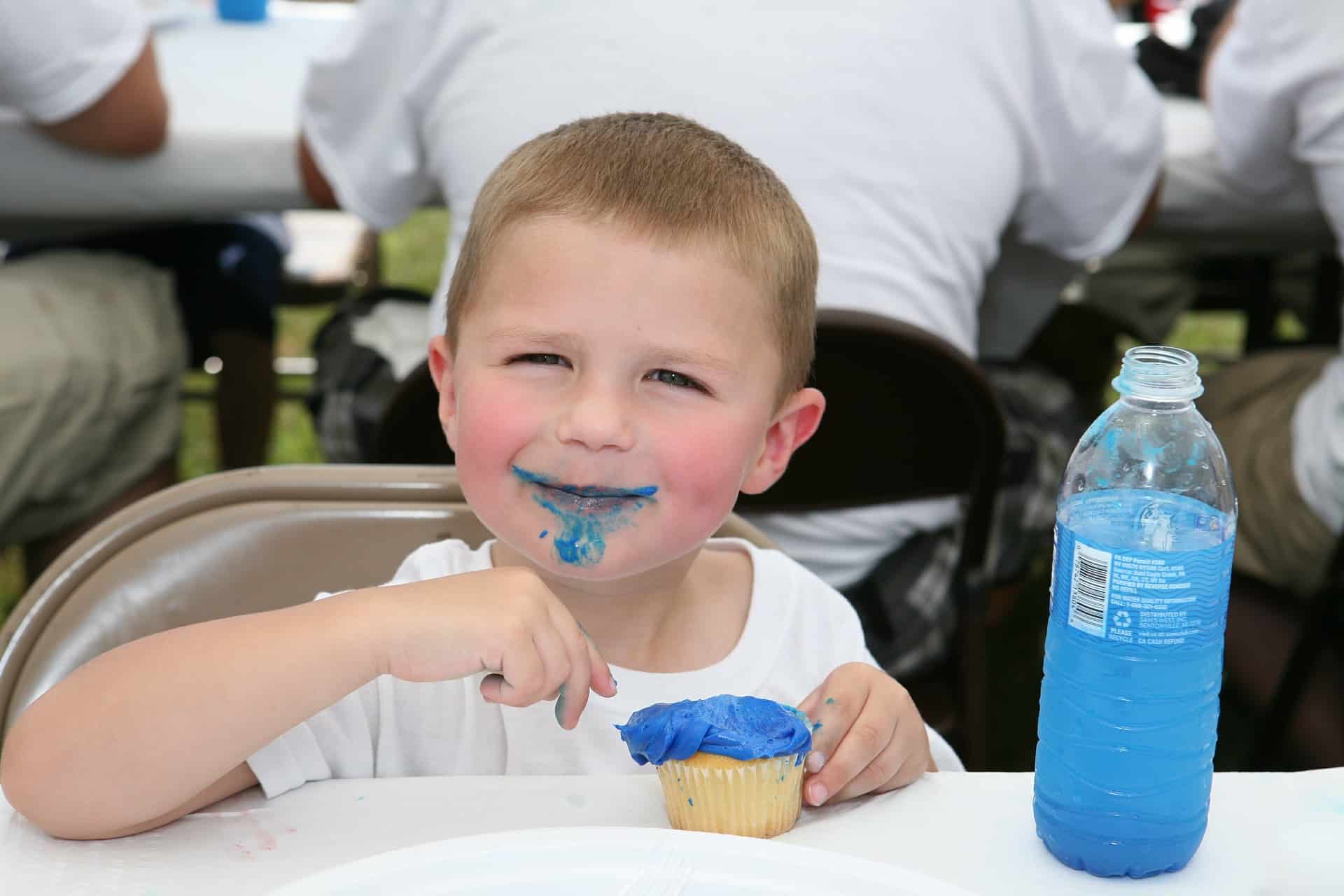 Child happily eating a cupcake. The connection between food and comfort begins at a young age, but can lead to emotional eating.