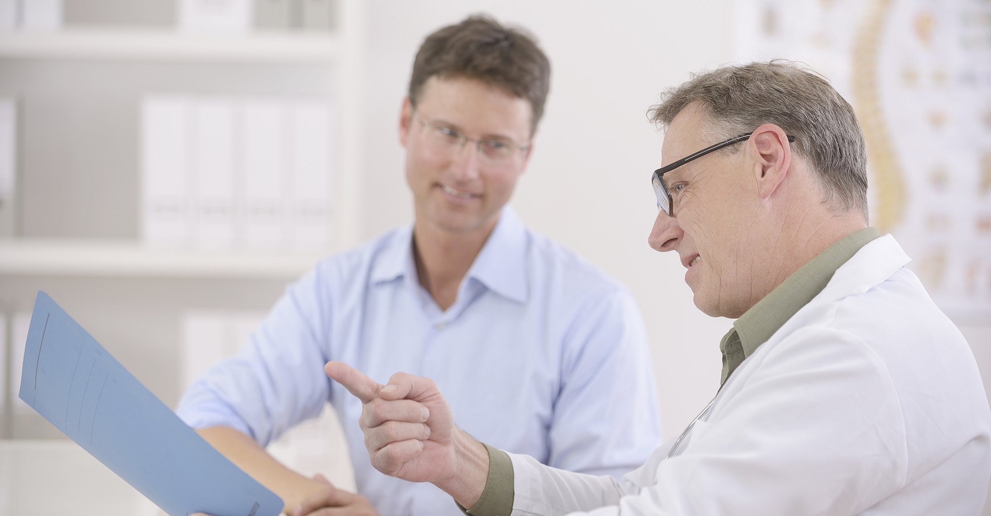 Two doctors looking at and discussing the results of a patient.