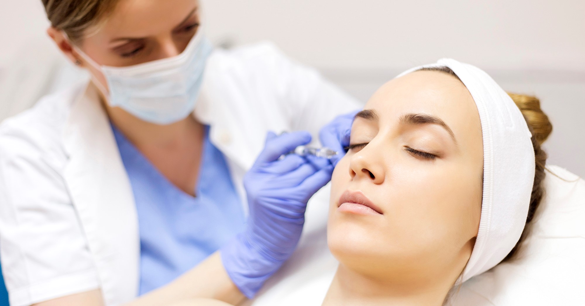 Cosmetic treatments is one of the reasons Harley Street is popular for cosmetic tourism. In this image, a client is laying down with her eyes closed while being injected with botox by a specialist.