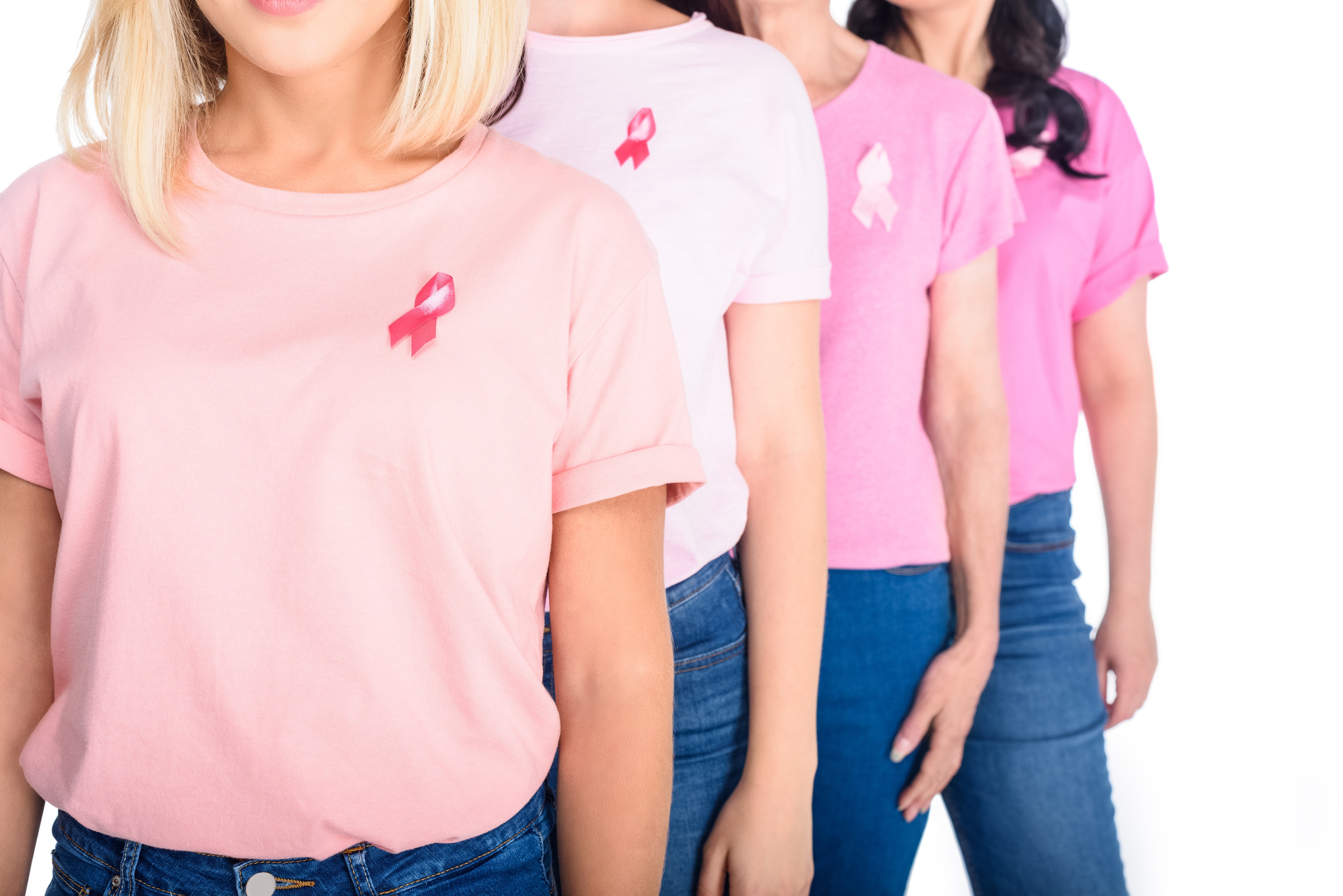 Research advances allow millions of women to receive better treatment, faster diagnoses and support. In the image, four women are standing with blue jeans and pink tops of different shades.