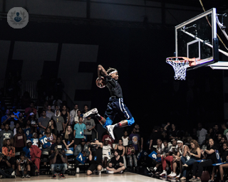Basketball player jumping to score a slam dunk