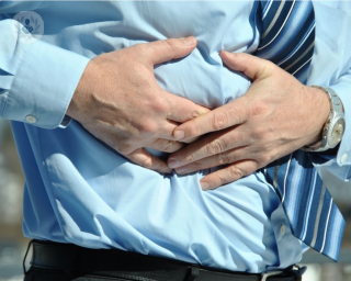 Man holding his stomach due to hernia pain