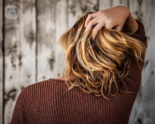 an image of a woman putting a hand through her hair
