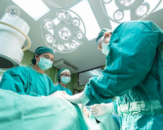 A team of surgeons operating on someone.