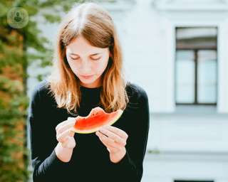 girl eating a slice of watermelon 