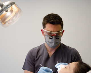 A picture of a dentist treating a patient 