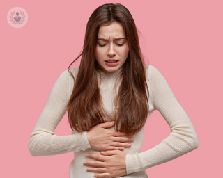 Woman in pain holding her stomach
