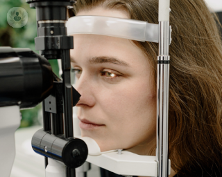 A picture of a woman geting her eyes tested