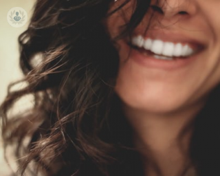 A woman smiling. 