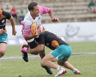 A rugby player tackling an opponent