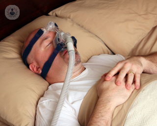 A man using a breathing machine to help with his sleep apnoea. 