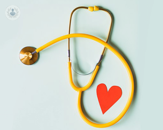 Bronze and yellow stethoscope with red paper heart cutout