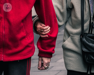 An old couple holding hands