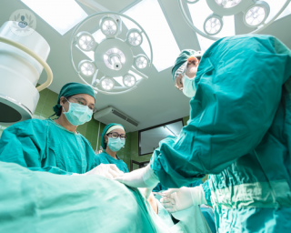 Group of surgeons undertaking gallbladder surgery