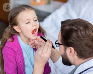 girl opening mouth for doctor to inspect tonsils