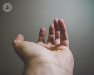 A hand is outstretched with the palm facing upwards. The photo has been taken from the forearm looking towards the fingers, making the wrist the main focus. 