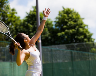 Female tennis player hitting a tennis ball