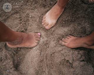 three feet on a beach