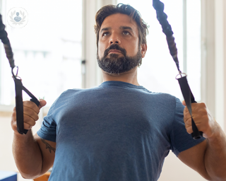 Man doing physical therapy exercises for his arms and shoulders