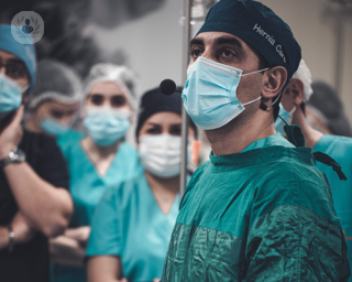 Surgeon undertaking hernia surgery