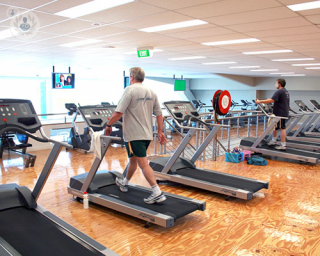A man doing exercise on a treadmill. 