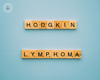 Scrabble letters spelling out Hodgkin lymphoma on a blue table
