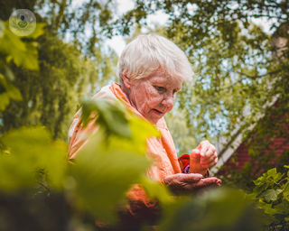 Elderly woman in a garden