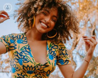 Smiling women with fabulous afro hair, outside on a sunny day