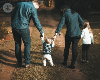 Family walking with a small child through the countryside