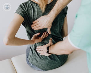 A woman having her back medically examined